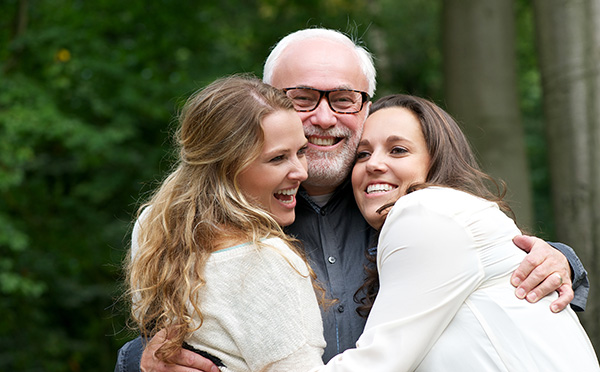 Father smiling with children